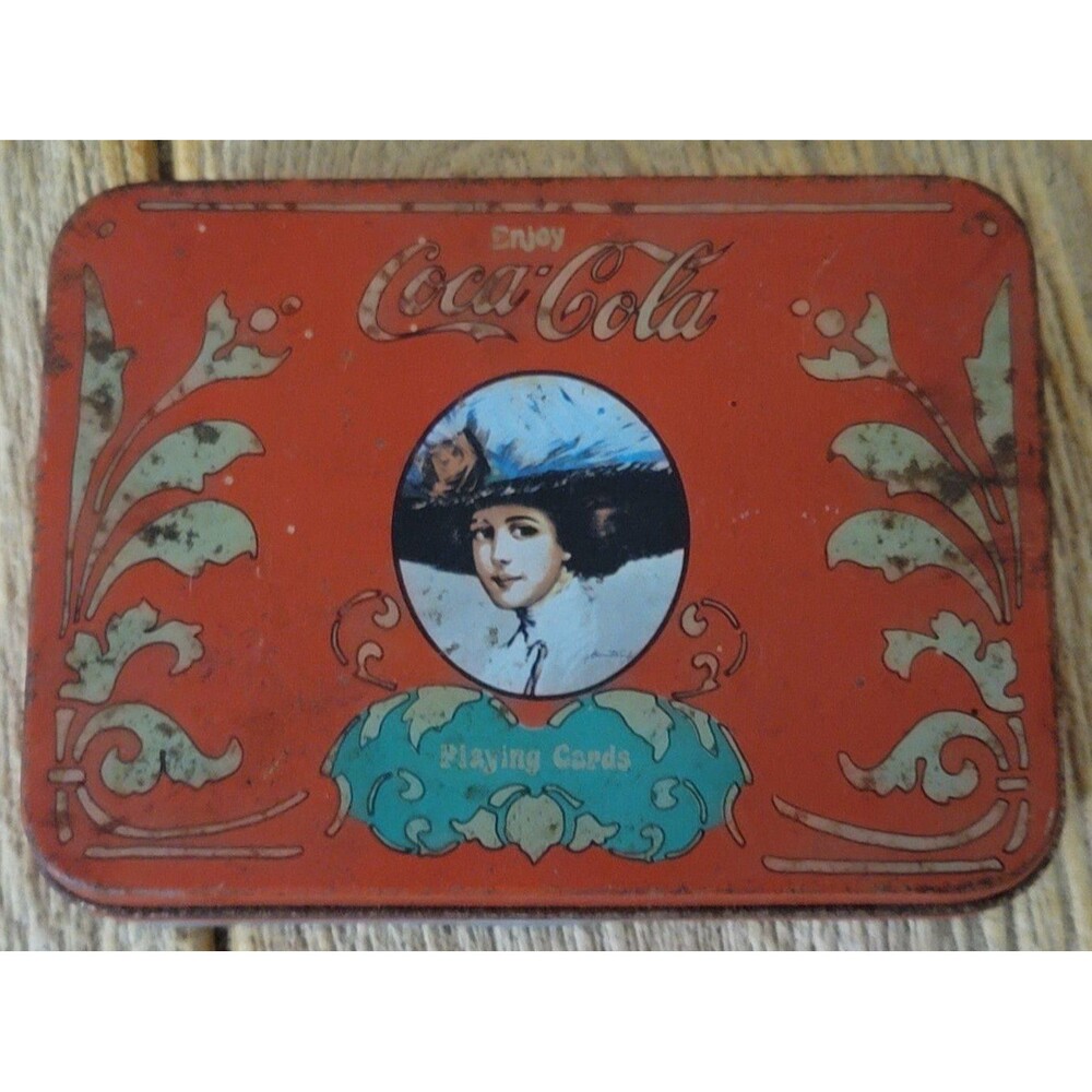 Coca-Cola card holding tin.